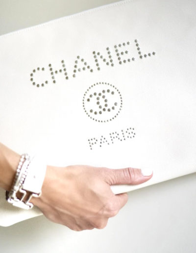 woman holds a chanel clutch bag during a photography shoot with surrey social stock photography