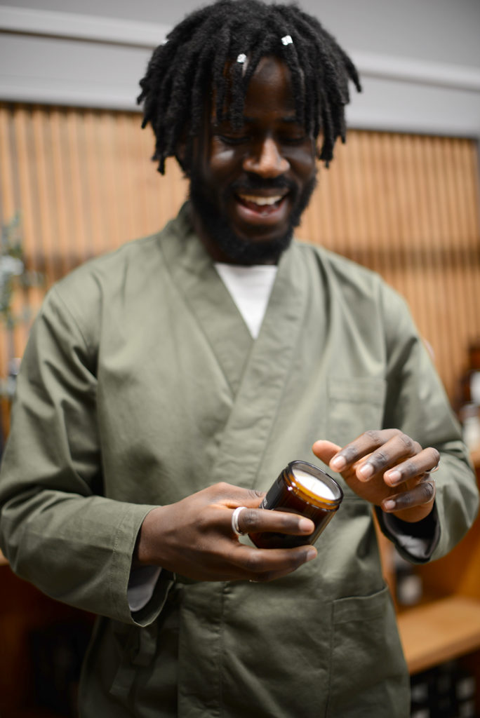 a man displays a candle during a retail business photo shoot by surrey social stock photography