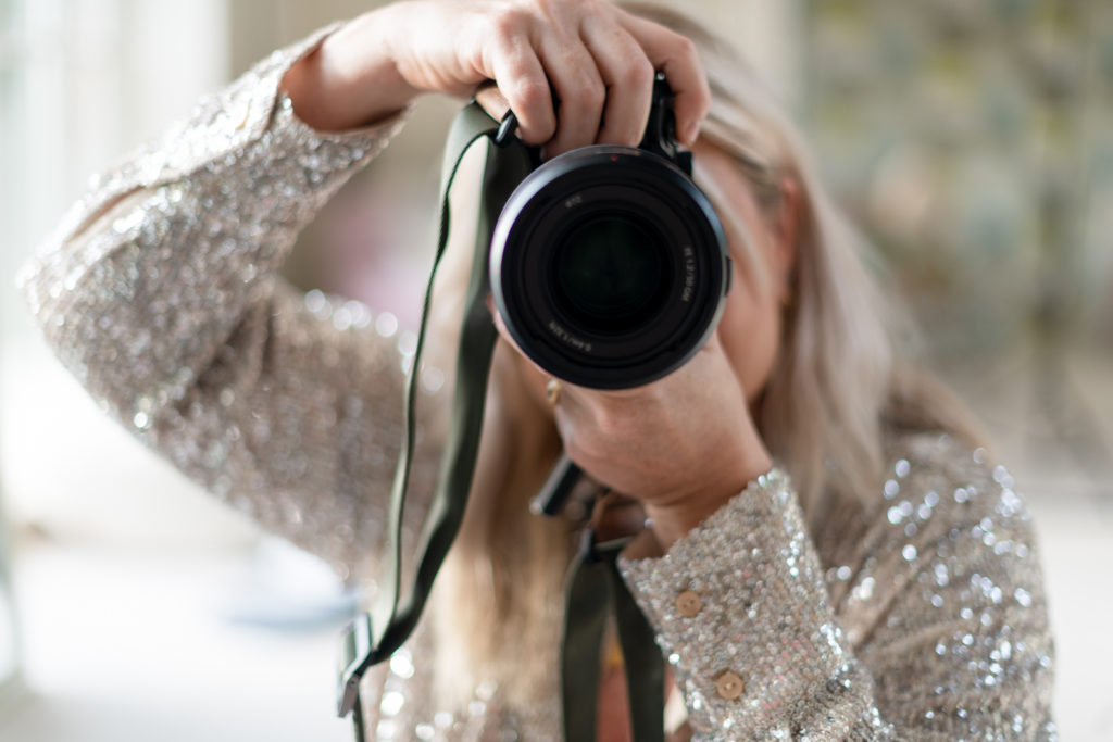 a woman takes a picture with her sony camera photographed by business photographers surrey social stock photography.