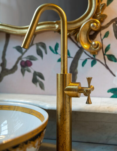 a gold tap in a restroom