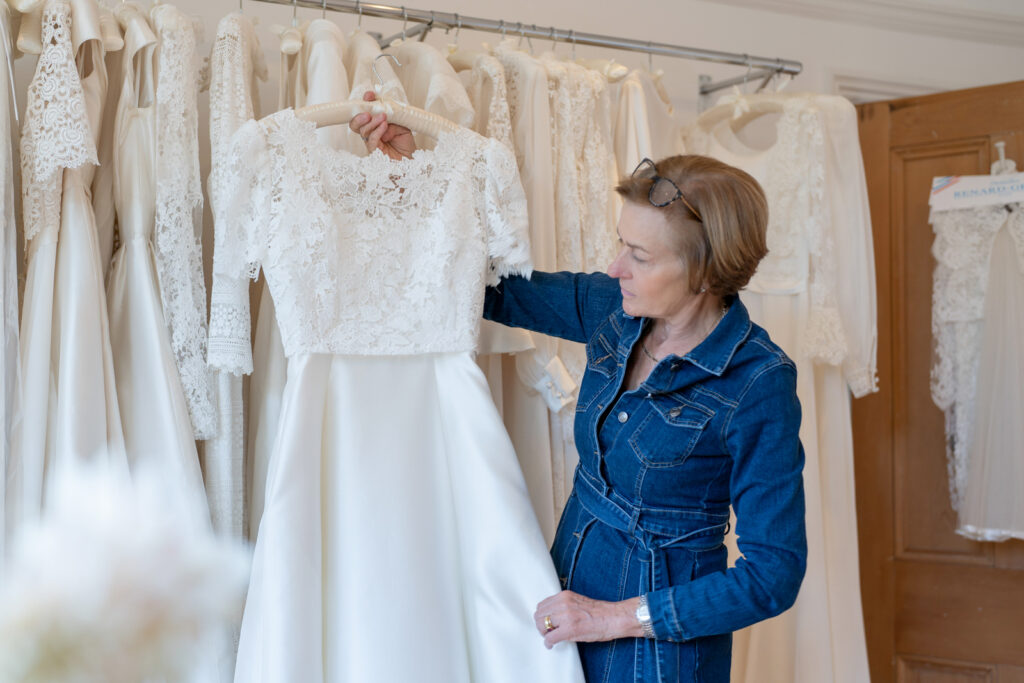a bridal designer shows of one of her wedding gowns during a personal brand photography shoot in kew