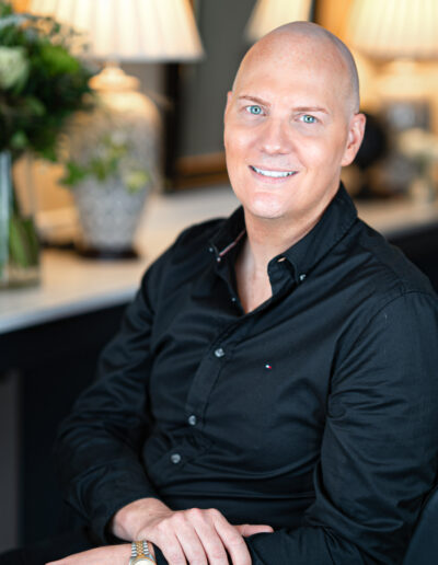a portrait of a hair dresser in his salon chair