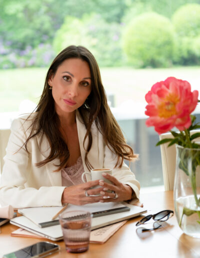 a business woman has a coffee at her desk
