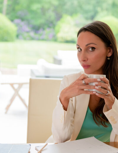 a business woman drinks a coffee at her desk