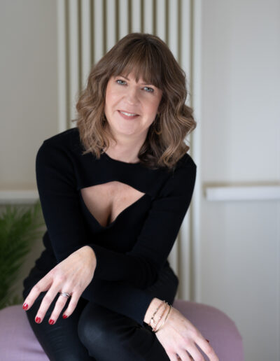 a woman poses for a photo during a personal brand photo shoot