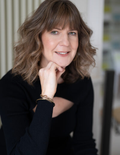 a woman poses for a photo during a personal brand photo shoot