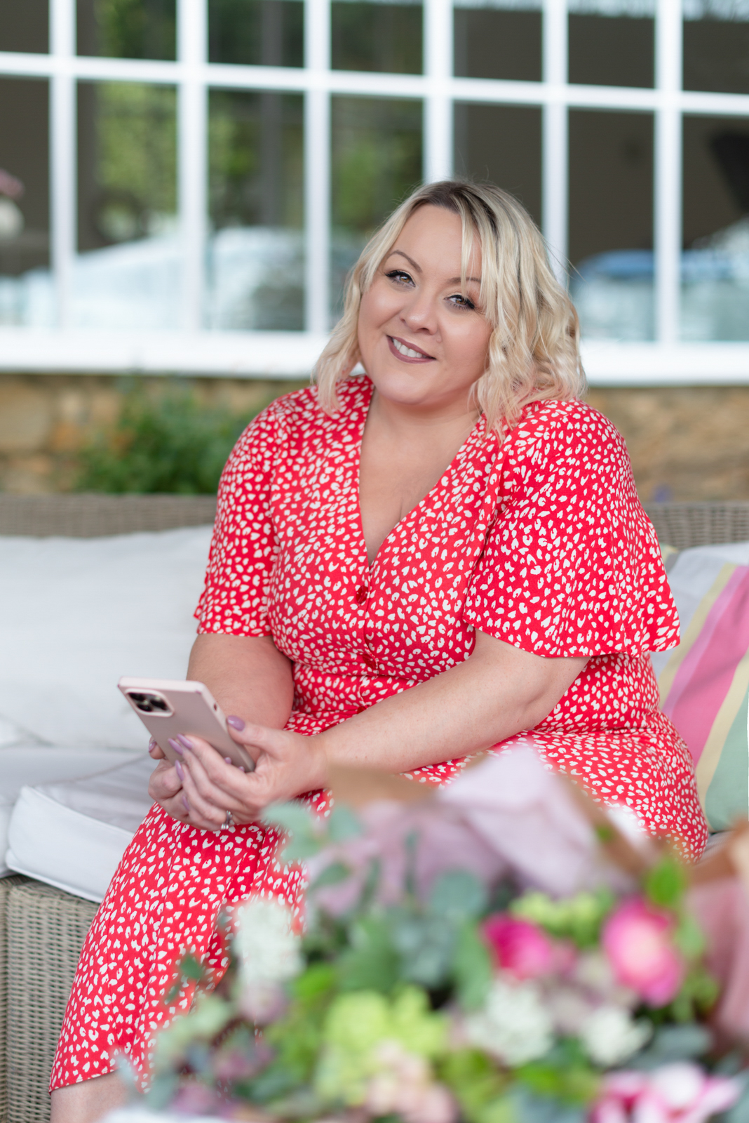 woman sits at her desk with a cup of coffee checking her computer