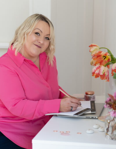 a woman works at her desk during a personal brand photo shoot in surrey