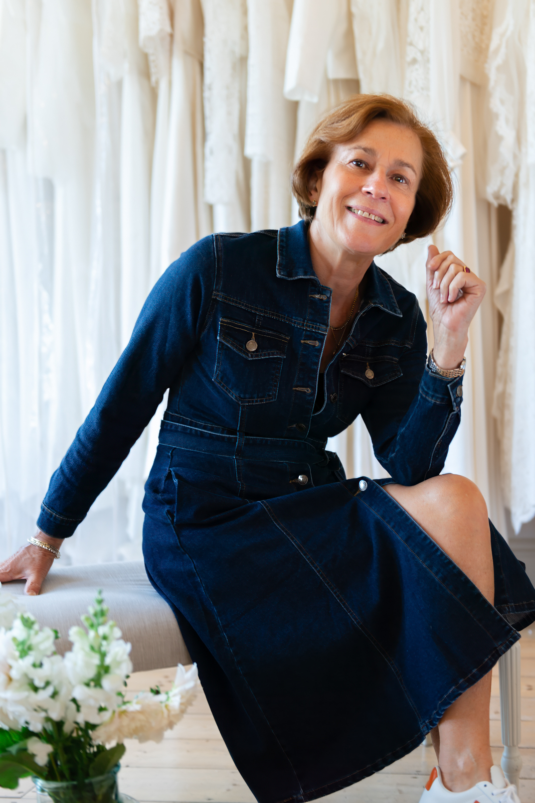 a bridal designer poses for a photo in her studio during a personal brand photography shoot