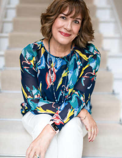a woman poses on some stairs during a personal brand photo shoot in surrey