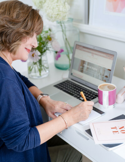 a stylist works at her desk during a personal brand photo shoot in surrey