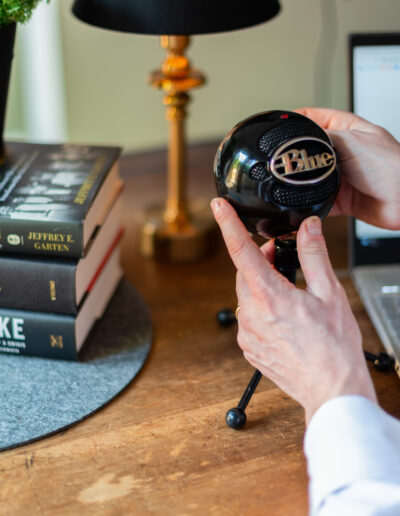 a man adjusts his podcast microphone during a personal brand photo shoot in surrey
