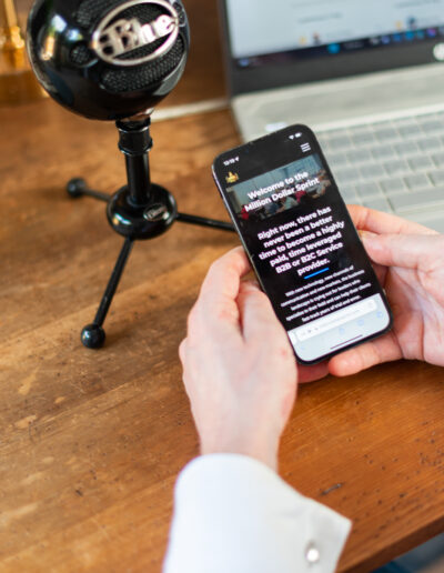a man checks his podcast equipment during a personal brand photo shoot in surrey