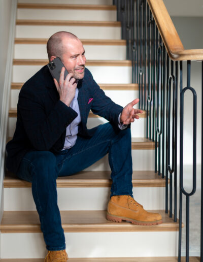 a man talks on his mobile during a personal brand photo shoot in surrey