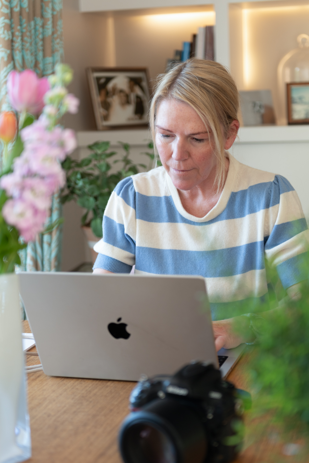 sssmay26-9 a woman checks her instagram feed at her home office desk photographed by business photographers surrey social stock photography.